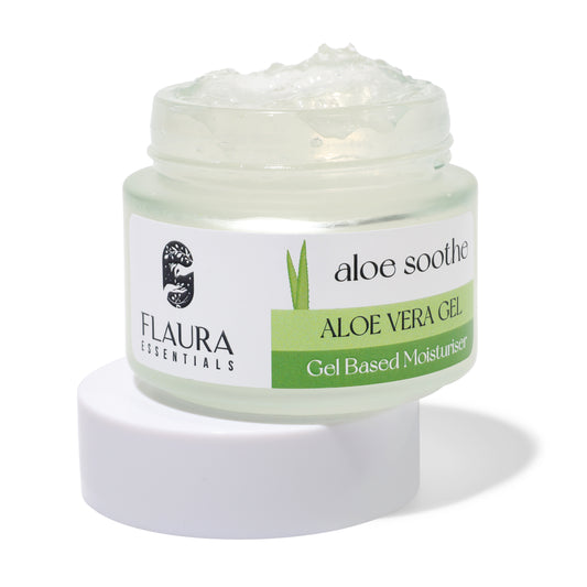 Image of an open jar of Flaura Essentials Aloe Vera Multi-Purpose Beauty Gel, labeled as "aloe soothe" and "Gel Based Moisturiser." The jar is light green with a white lid, containing a transparent gel. Perfect for skin care and natural healing, the label features a logo and green, white, and black text.